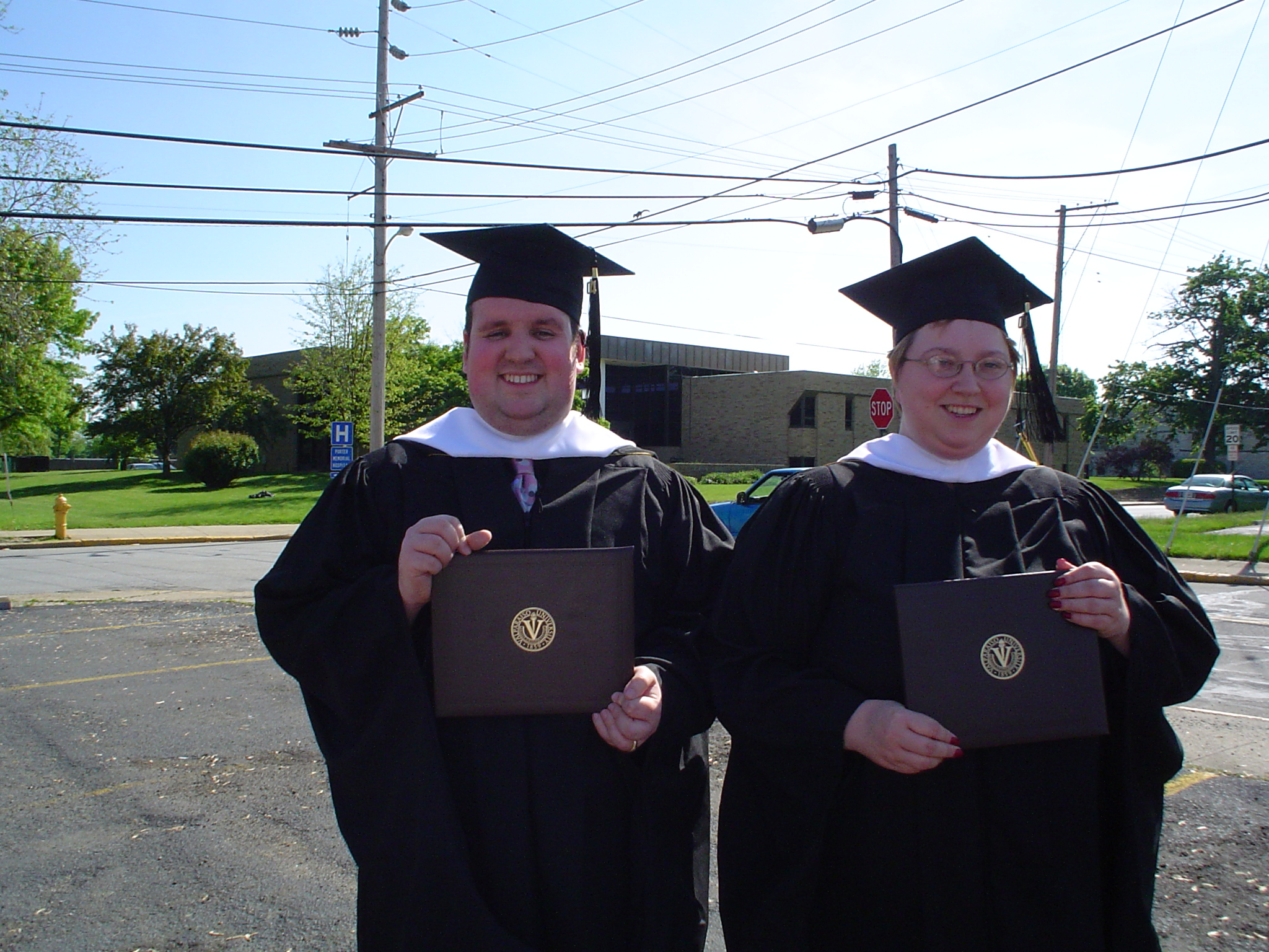 Graduation - This is my DH and our friend at their graduation from the MLAS program at Valparaiso University in 2003.  It was a nice day.  The picture was taking in the parking lot!
