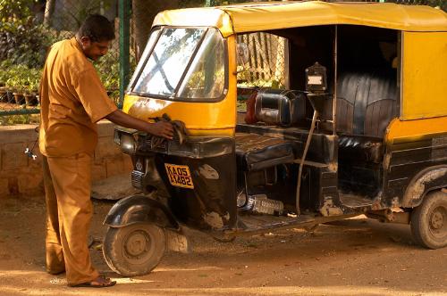 Auto-Rickshaw - Man cleaning his rickshaw early morning.