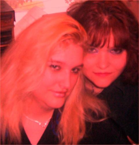 My sister and me - This is a photo taken of my sister and me. I used adobe image editor to add the red tinge.