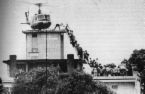 Fall of Saigon - Shows a helicopter on top of the US Embassy in Saigon and people scrambling up a ladder to get aboard