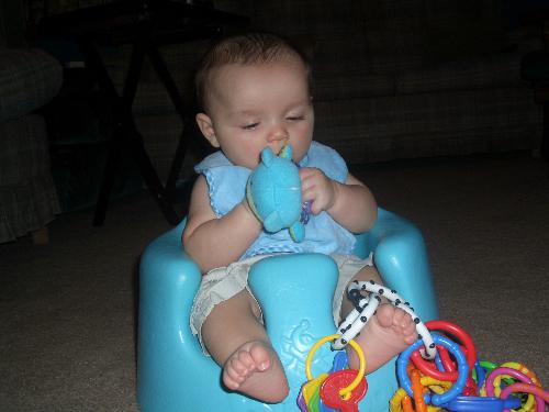 Graysen in his Bumbo - graysen playing in Bumbo