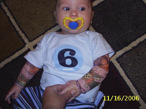 My Baby boy - Here is my baby boy his shirt says 6m but he is actually 5 just wear a 6-12 m  and they dont make a 6-12 m sized shirt that says 5m  but anyway I added the sleeves to the shirt. so he could have tatoos like daddy..  we get lots of attention at the store for it.. but it's ok..