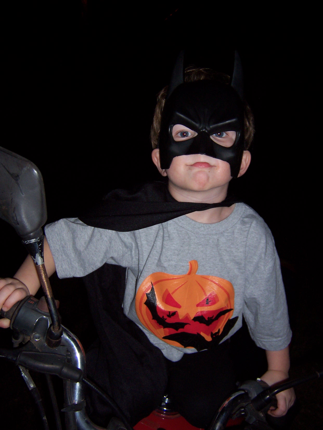 The Bat Boy Cycle - This was last year's Halloween.  I still love this picture.  We did a modified Batman for his costume and when we were out on the porch greeting trick or treaters he kept climbing up on my husband's motorcycle and I snapped this photo.  He was calling himself Bat Boy by that time, and so I christened the picture, The Bat Boy Cycle!