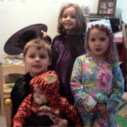 My kids in their costumes - This was Thursday before we went trick or treating.  They were Tigger, Batman, a witch and a clown.  I made all the costumes except the Tigger one, which we bought for our oldest in 2001.  They have all worn the Tigger costume for their first trick or treat event.