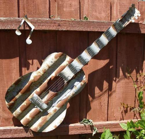 Guitar made from Corrigated Iron - After buying the corrigated iron map of Australia I asked the fella who made it if he could make me a Guitar, this was a challenge for him and this is what he came up with.