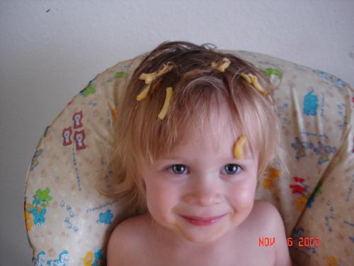 macaroni pic number two - my daughter proud of her acomplishment of a hat of macaroni. This is not the same picture on my profile.