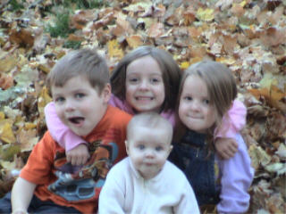 My 4 kids in the leaves - My kids playing in the leaves in November 2006.