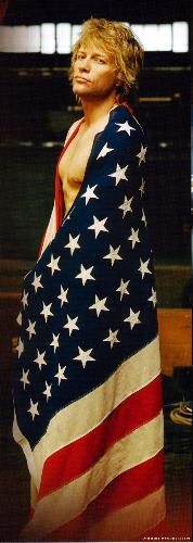 Jon Bon Jovi - Jon Bon Jovi and the United States flag wrapped around his partly (?, you'll never know, hehehe) naked body. 'Have A Nice Day' promo picture.