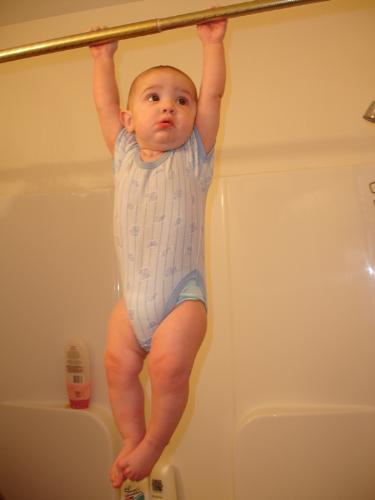 blake hanging out - my son (5 mths old at the time) hanging from the shower curtain rod. lol