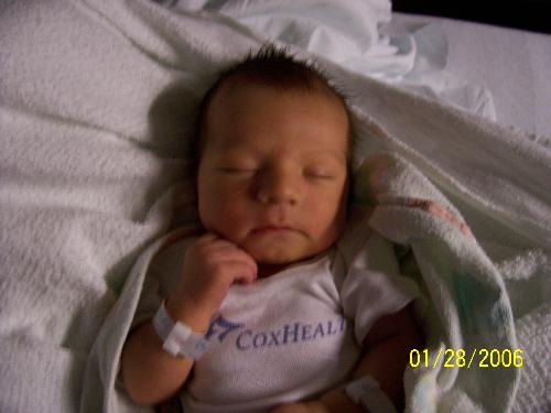 Logan at 5 days old - Our family was complete alas!! Logan was born January 23rd!! Just happens to be on his daddy's!