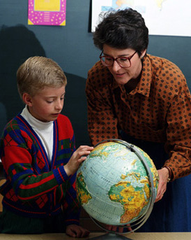 A Child with ADHD - This is a photo of a boy with ADHD being taught geography by a teacher. He needs special education.