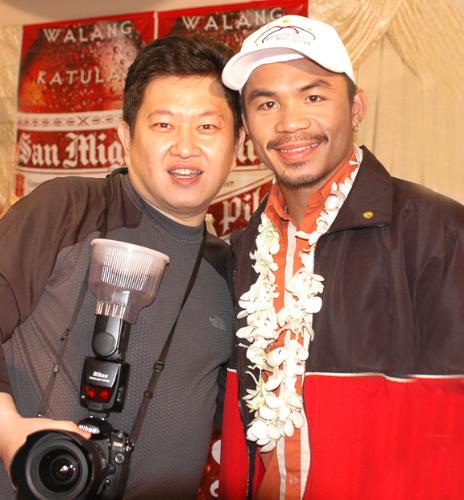 Manny Pacquiao with my famous Philippine photograp - Taken at the Manila International airport when Manny Pacquiao returned to his country after a successful win in 2005. Philippine photographer Patrick Uy poses with Manny in this momentous return trip to his homeland - The Philippines - land of champion boxers.
