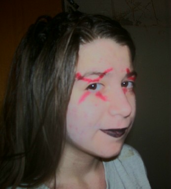 my daughter painted up for Halloween - dark haired teen authoress, painted up for halloween