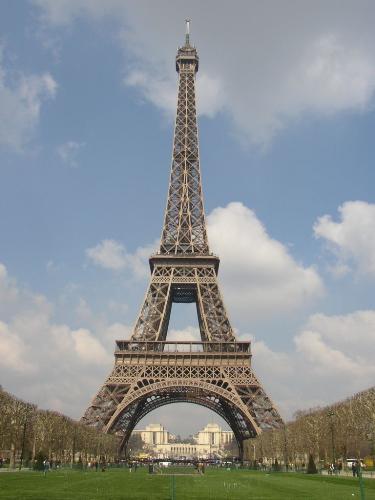 Eiffel Tower... - The Eiffel Tower (pronounced /'aif?l'ta??/; French: La Tour Eiffel, pronounced /'tur,e'fel/) is an iron tower built on the Champ de Mars beside the River Seine in Paris. It is the tallest structure in Paris and possibly the most recognized symbol in the world. Named after its designer, engineer Gustave Eiffel, it is the most visited monument in the world; 6,428,441 people visited the tower in 2005 and more than 200,000,000 since his construction. Including the 20.75 m (70 ft) antenna, the structure is 320.75 m (1070 ft) high which is about 81 stories. Completed in 1889, the tower replaced the Washington Monument as the tallest structure in the world, a title it retained until 1930. In 1902, it was struck by lightning, which caused builders to reconstruct 300 feet of the top. The lights illuminating the tower also had to be replaced, due to short-circuiting.  At the time of its construction in 1889, the tower replaced the Washington Monument as the world's tallest structure in the world, a title it retained until 1930, when New York City's Chrysler Building (1063.33 ft tall) was completed. The tower is the second-highest structure in France, after the Allouis longwave transmitter, built in 1930. The Eiffel Tower is the highest structure in Paris, the second-highest structure in Paris is the Tour Montparnasse.  The structure of the Eiffel Tower weighs 7,300 tons. There are 1660 steps. It is not possible for the public to reach the summit via the stairs, elevators are required beyond the second platform.  Depending on the ambient temperature, the top of the tower may shift away from the sun by up to 3.25 inches, due to thermal expansion of the metal on the side facing the sun.  Maintenance of the tower includes applying 50/60 tons of three graded tones of paint every seven years to protect it from rust. On occasion, the color of the paint is changed — the tower is currently painted a shade of brownish-gray. However, few people realize that the tower is actually painted three different colors in order to make it look the same color. The colors change from dark to light from top to bottom, but it looks the same because of the background (the sky being light and the ground being dark). On the first floor, there are interactive consoles hosting a poll for the color to use for a future session of painting.