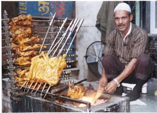 Tandoori Chicken - This is a photograph of a man roasting chicken in a shop in Lucknow(Got it from google). Although you can get roasted chicken almost anywhere in the world but lucknow ke murge ki to baat hi nirali hai. The masala used to marinate the chicken is simply amazing