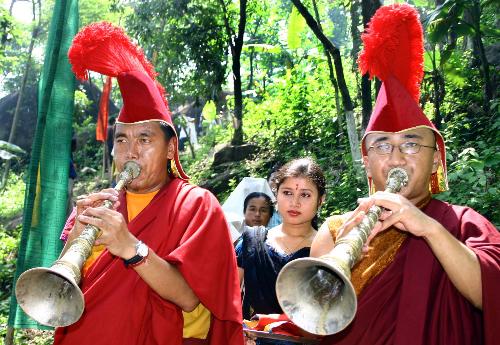 Budhist monk ,assam - budhist monk playing traditional trumpet at assam india on budha jayanti