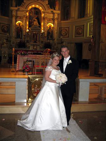 The newlyweds! - My husband and I in front of the altar at the church after we got married!