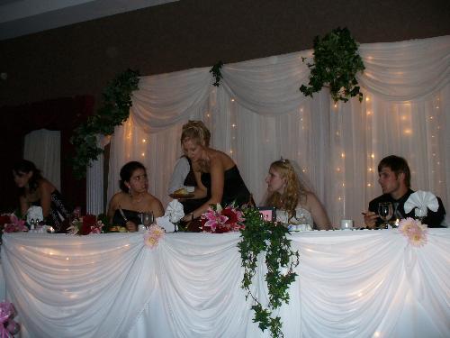 The Knife Fight - Carla and I seemingly fighting over a bun that Laurie has.  Funniest wedding picture ever!