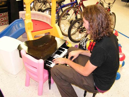 Mmmm piano - Me playing a little toy piano at Goodwill.