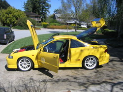 honda integra - it's color is yellow and it's two doors...