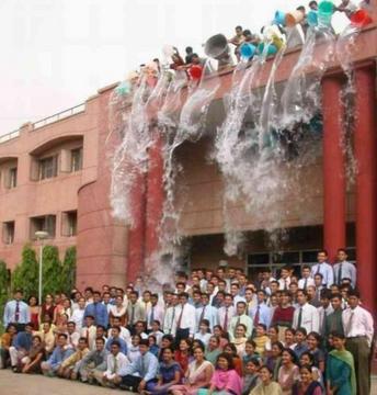 Practical joke done with hunderds of students - this is a picture taken at the annual function of a local college, some miscievious guys can be seen throwing water from buckets on the well-dressed lot.