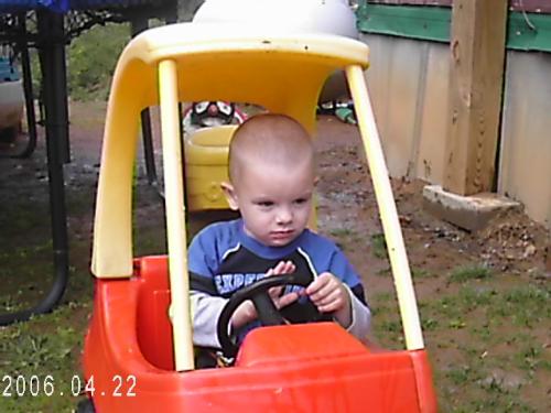 my son Tyler - Tyleris in his car.He thinks he is going to learn to drive early.Hes getting his practice.