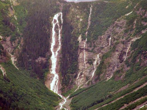 Massive Waterfall - Here is a good picture of a great big waterfall, this waterfall might not look that big but trust me it's huge, there are several smaller waterfall's that all combine into one in this photo and the water is comming from a lake on top of that mountain, the lake is being supplied by a glacier.