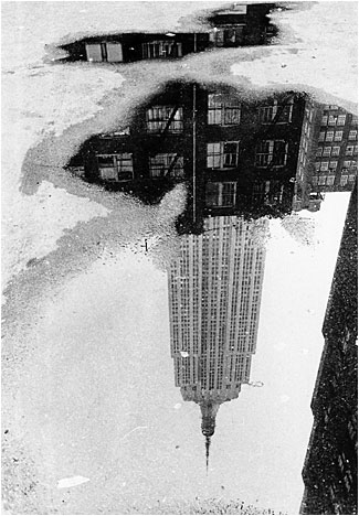 Puddle, Empire State Bldg  - a photo taken by Andre Kertesz in 1967. American photographer born in the Austro-Hungarian Empire