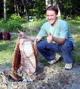 Cooking a Rib Tree - Me in front of my rib tree - an inverted tomato tower over a pit of coals and smoking wood chips covered in pork ribs.  It took 8 hours too cook the ribs, but man were they good!
