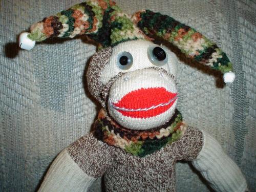 Jester monkey close up - I made this monkey and crocheted the hat and made the gourd swing and the crocheted pillow he's sitting on.