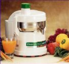 Electric Juicer - photo of an electric juicer surrounded by fruits and vegetables.