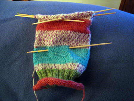 Knitted Sock in progress - .JPG image of a knitted sock in progress, using double pointed needles and self-striping sock yarn.