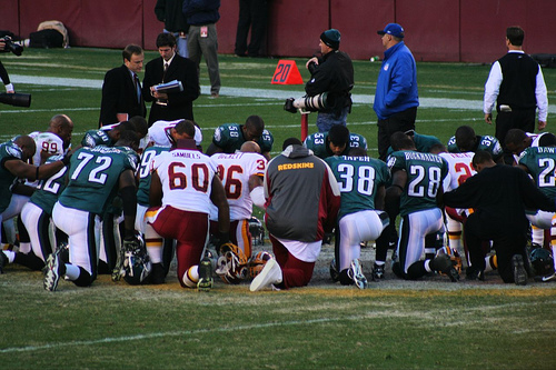 Washington Redskins vs. Phlidephia Eagles pt. 1 - The players on the filed praying together before the game starts.