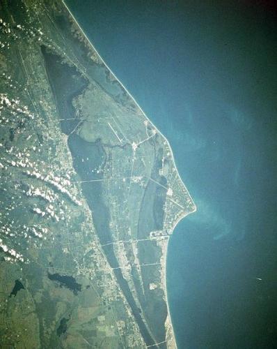 Cape Canaveral - Cape Canaveral is a strip of land in Brevard County, Florida, United States, near the center of that state's Atlantic coast at 28°33'21?N, 80°36'17?W. It is part of a region known as the Space Coast, and is the site of the Kennedy Space Center, and the Cape Canaveral Air Force Station. Many United States spacecraft are launched from either one of these sites; as a result, the term 'Cape Canaveral' or 'Canaveral' is used to refer to either location. It sits due east of Merritt Island, separated from it by the Banana River.  Other features of the cape include Cape Canaveral lighthouse and Port Canaveral. The city of Cape Canaveral is a few miles south of the cape.  The first rocket launch from the Cape was Bumper 8 from Launch Pad 3 on 24 July 1950. On February 6, 1959 the first successful test firing of a Titan intercontinental ballistic missile was accomplished here. All manned U.S. government (NASA) spaceflights have launched from Cape Canaveral.  Cape Canaveral was chosen for rocket launches to take advantage of the earth's rotation. The centrifugal force of this rotation is greatest at the equator, and to take advantage of it, rockets are launched eastward, in the same direction of the earth's rotation. It is also highly desirable to have the downrange area sparsely populated, in case of accidents; an ocean is ideal for this. Although the United States has sites closer to the equator with expanses of ocean to the east of them (e.g. Hawaii, Puerto Rico), the east coast of Florida has substantial logistical advantages over these island locations.
