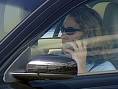 mobile car driving - This photo shows the driver of A car with a mobile in her hand