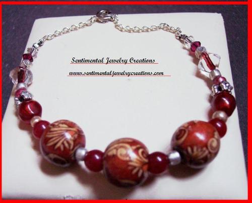 Red Sunflower Bracelet that I made - This is a bracelet handstrung with wooden sunflower beads and glass red beads. It was also strung on silver plated string. It sold on Ebay.