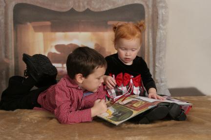 Christmas 2006 - Jake and Sami reading a book by the fireplace.