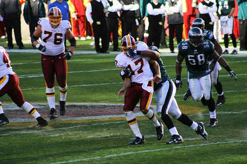 Washington Redskins vs. Phlidephia Eagles pt. 17 - One of the washington redskins players running with the ball and getting his face mask grabbed.
