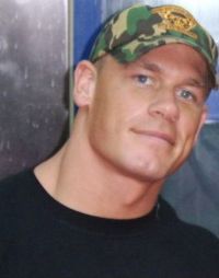cena - John Felix Anthony Cena, Jr. (born April 23, 1977), is an American professional wrestler, rap music artist and actor who wrestles on the RAW brand of World Wrestling Entertainment (WWE), where he is the reigning WWE Champion. Cena's first televised WWE match was in answer to an open challenge by Kurt Angle on June 27, 2002. Inspired by Vince McMahon's speech to WWE's rising stars, exhorting them to show 'ruthless aggression' to earn a place among the legends, Cena took advantage of the opportunity and almost beat Kurt Angle kicking out of the Angle Slam and enduring the ankle Lock submission hold, but ultimately lost to a hard, amateur-style pin.  Cena then played the role of a typical underdog face in each match. After losing alongside Billy Kidman in a tournament match for the WWE Tag Team Championships, Cena turned heel, blaming Kidman for the loss. Shortly after his heel turn, on a Halloween episode of SmackDown!, he performed a freestyle rap for Stephanie McMahon while wearing a Vanilla Ice costume prompting a gimmick change to a white rapper. At first, this gimmick got Cena heel heat from the fans, but his frequent comical 'freestyles' about other wrestlers helped to gain him a following. During this time Cena adopted the classic WWF logo (without the 'F') along with the slogan 'Word Life' as his 'signature symbol'. He was joined by an enforcer, first B-2 (also written as B², pronounced 'B-Squared'), who was later replaced by Rodney Mack under the moniker 'Red Dogg'.