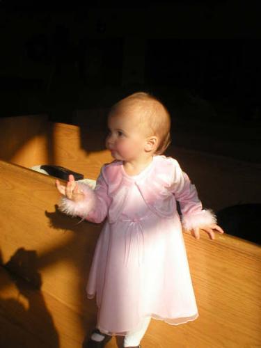 Baptism baby - Unfortunately, they don't make baptism gowns in size 18 month, so I went with a cute pink dress for her baptism that was just around Thanksgiving. My mom took this picture, isn't it great?