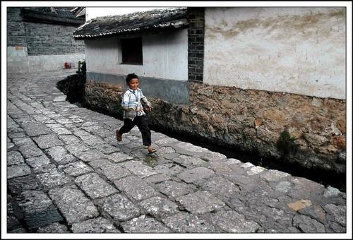 Running - PHOTO OF A BOY RUNNING IN A STREET IN Lijiang - Yunnan