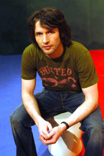 James Blunt picture gallery - Take 'No Bravery', the song that closes his debut album, 'Back to Bedlam', for instance: It was written in Kosovo in 1999, while James was a reconnaissance officer in the British army. On patrol around Pristina, he kept his guitar bolted to the outside of his tank. But in quieter moments, it came out, as he wrote about life as a 22-year-old peacekeeper in the aftermath of one of the decade's bloodiest civil wars. The rest of his unit ordered him to keep the noise down as he wrote and sang in the post-midnight stillness. He didn't keep the noise down. ''No Bravery' is the only complete song I wrote in Kosovo. I wrote it lying by my tank in my sleeping bag with my boots on. You had to sleep with your boots on. The song is pretty fatalistic. The rest of the album is fatalistic,' he says wryly.