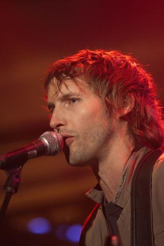 James Blunt picture gallery - Take 'No Bravery', the song that closes his debut album, 'Back to Bedlam', for instance: It was written in Kosovo in 1999, while James was a reconnaissance officer in the British army. On patrol around Pristina, he kept his guitar bolted to the outside of his tank. But in quieter moments, it came out, as he wrote about life as a 22-year-old peacekeeper in the aftermath of one of the decade's bloodiest civil wars. The rest of his unit ordered him to keep the noise down as he wrote and sang in the post-midnight stillness. He didn't keep the noise down. ''No Bravery' is the only complete song I wrote in Kosovo. I wrote it lying by my tank in my sleeping bag with my boots on. You had to sleep with your boots on. The song is pretty fatalistic. The rest of the album is fatalistic,' he says wryly.