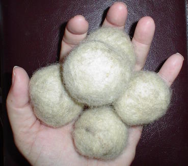 Making Felted Juggling Balls - The next step is to add pretty dyed wool in bright colors and felt them again until they are the right size.