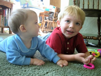 kids - 2 Kids laying on floor.