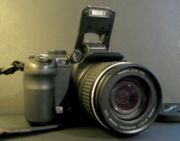 Digital Camera - Also called digicams, this encompasses most digital cameras. They are characterized by great ease in operation and easy focusing; this design allows for limited motion picture capability. They tend to have significantly smaller zooms than prosumer and DSLR cameras. They have an extended depth of field. This allows objects at a larger range of depths to be in focus, which accounts for much of their ease of use. It is also part of the reason professional photographers find their images flat or artificial-looking. They excel in landscape photography and casual use. They typically save pictures in only the JPEG file format.