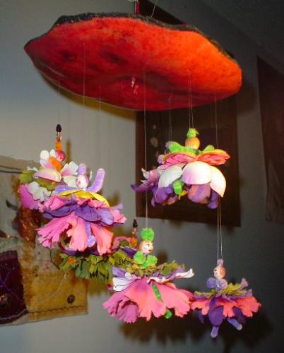 Gourd mobile Dancing Girls - The top is a slice of gourd. Each doll has a wooden bead for a head and a pipe cleaner body and flower petal skirts.