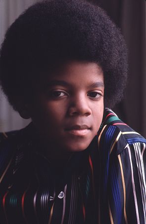 Michael Jackson - Michael Joseph Jackson (born August 29, 1958) is an American musician, entertainer and pop icon, whose successful music career and controversial personal life have been a part of pop culture for the last quarter-century.  Jackson began his musical career at the age of seven as the lead singer of The Jackson 5 and released his first solo recording, Got to Be There in 1971, while remaining a member of the group.[2] He began a full-fledged solo career in 1979 and formally parted with his siblings in 1984.[3] In his solo career, Jackson recorded and co-produced the best-selling album of all time, Thriller, which was named as the world's best-selling album at the 2006 World Music Awards. It has worldwide sales exceeding 104 million.[4] Michael Jackson has received thirteen Grammy awards[5] and charted thirteen number-one singles in the United States.  Throughout his four-decade career, Michael Jackson has been awarded numerous honors including the World Music Award's Best-Selling Pop Male Artist of the Millennium, American Music Award's Artist of the Century Award[6] and the Bambi Award's Pop Artist of the Millennium Award.[7] He is a double-inductee of the Rock and Roll Hall of Fame (once as a member of The Jackson 5 in 1997, and as a solo artist in 2001)[8] and an inductee of the Songwriters Hall of Fame.[9] Raymone Bain, Jackson's PR, claims that Jackson has sold over 750 million units worldwide.[10]  From 1988 to 2005, Jackson lived on his Neverland Ranch property, on which he built an amusement park and private zoo that was frequently attended by disadvantaged and terminally ill children. Rumours of sleepover parties received disparaging media coverage after it was revealed that children frequently slept in his bed or bedroom. These first came to light when he was accused of child sexual abuse in 1993. Michael Jackson's relationship with children was brought into the spotlight again in 2003 during the TV documentary Living with Michael Jackson. This resulted in Jackson being tried, and later acquitted, of more child molestation allegations and several other charges in 2005. Contents [hide] 1 Biography  1.1 1966–1980: Early life and career 1.2 1982–1986: The Thriller era 1.3 1987–1990: Bad and controversies 1.4 1991–1994: Dangerous and further career 1.5 1995–2000: HIStory and Blood on the Dance Floor 1.6 2001–2003: Invincible, Berlin and Martin Bashir 1.7 2003–2006: Trial, acquittal and the aftermath 1.8 2006–present: Visionary, Tokyo and the World Music Awards 2 Discography  2.1 Studio albums 2.2 Number-one singles  2.2.1 US number-one singles 2.2.2 UK number-one singles 3 Filmography  3.1 Notable music videos 3.2 Films 3.3 Videos/DVDs 3.4 Television 3.5 Video games 4 Music samples 5 Further reading 6 References 7 See also  7.1 Michael Jackson articles 7.2 Other related articles 8 External links  Biography  1966–1980: Early life and career Main articles: The Jackson 5 and Off the Wall   The cover to Michael Jackson's 1971's Got to Be There.  Michael Jackson was born in Gary, Indiana. He is the second-youngest brother of seven and the eighth of ten children of Joseph and Katherine Jackson. In 1966, after taking co-lead singing duties with brother Jermaine, the group's name changed from The Jackson Brothers to The Jackson 5. The group played at local clubs and bars, building up a following and eventually signing a contract with Motown Records in 1968.[11] The group hit stardom, with their first four singles which charted at number-one on the Billboard Hot 100. As a solo artist, Jackson released Got to Be There and Ben in 1972. These were released as part of the Jackson 5 franchise and produced successful singles such as 'Got to Be There', 'Ben', and a remake of Bobby Day's 'Rockin' Robin'.  The group's sales declined after 1973, and the group chafed under Motown's strict refusal to allow the Jacksons creative control or input. In 1976, the group signed a new contract with CBS Records (first joining the Philadelphia International division and then Epic Records).[12] When this became apparent to Motown Records, they sued the group for breach of contract.  As a result of the legal proceedings, which were complicated further by the fact that Jermaine Jackson was married to the daughter of Motown president (Berry Gordy), the Jacksons lost the rights to use the 'Jackson 5' name and logo and also Jermaine, who wanted to stay at Motown.[13] They changed their name to 'The Jacksons', featuring youngest brother Randy in Jermaine's place, and continued their successful career, touring internationally and releasing six more albums between 1976 and 1984, with Jermaine eventually re-joining in 1983, making them a sextet.  In 1978, Jackson starred as the scarecrow in The Wiz with former-label mate Diana Ross playing Dorothy.[14] The songs for the musical were arranged by Quincy Jones, who established a partnership with Jackson during the film's production and agreed to produce his first solo album in four years. Off the Wall, released in 1979, was a worldwide hit, and became the first album in history to spawn four top-ten hits, including 'Don't Stop 'Til You Get Enough' and 'Rock with You'.[2]  In January 1980, Jackson won his first awards for his solo efforts at the American Music Awards. He won 'Favorite Soul/R&B Album' (for Off the Wall), 'Favorite Male Soul/R&B Artist' and Favorite Soul/R&B Single (for 'Don't Stop 'Til You Get Enough').[2] Later that month, he also won two Billboard Awards (for 'Top Black Artist' and 'Top Black Album').[2]  On February 27, 1980, Jackson won a Grammy Award for 'Best R&B Vocal Performance, Male' (for 'Don't Stop 'Til You Get Enough').[2]  1982–1986: The Thriller era Main articles: Thriller (album), We Are the World, and Captain EO   The original album cover to 1982's Thriller.  In November 1982, the storybook for E.T.: The Extra-terrestrial was released. It included Jackson reading the story as well as one original song ('Someone in the Dark'). The album later won a Grammy for 'Best Album for Children'.  In December 1982, Jackson released his second Epic album, Thriller, which became the best-selling album in music history. The album spawned seven hit singles, including 'Billie Jean' (which was the first music video by a black artist to receive regular airplay on MTV), 'Beat It' and the album's title track which was accompanied by a revolutionary music video. The thirteen-minute Thriller was critically acclaimed, and massive airplay lead to it being packaged with the featurette Making Michael Jackson's Thriller on VHS, where it became the best-selling music home video ever.[15] Thriller spent 37 weeks at number-one and remained on the Billboard album chart for 122 weeks. It was eventually certified 27x Platinum in the United States.[16]   Jackson with the Reagans in 1984.  In 1983, whilst performing 'Billie Jean' at the Motown 25: Yesterday, Today, Forever concert Jackson debuted what can be regarded as his signature move: the moonwalk.[15] In 1983, he started a sponsorship deal with Pepsi-Cola, and, as part of the deal, he agreed to star in a commercial. While filming a Pepsi commercial with his brothers in 1984, before a live audience, his hair caught on fire when a pyrotechnic effect went wrong. Jackson suffered serious burns on his scalp, which required skin grafts.[17]  In February 1984, Jackson is nominated for twelve Grammy awards and wins eight,[15] breaking the record for the most Grammy Awards won in a single year.[18] Seven were for the critically acclaimed Thriller and the other for the E.T.: The Extra-terrestrial storybook. In 1984, he also won eight American Music Awards and the 'Special Award of Merit' and three MTV Video Music Awards.  After reuniting with his brothers, he then helped to write the Victory album. He then performed and starred in the successful Victory Tour which started on July 6, 1984 and lasted for five months.[15]  In 1985, Jackson was invited to the White House and was personally thanked by then-President Ronald Reagan at a White House ceremony for donating the song 'Beat It' for use in drunk driving prevention television and radio public service announcements.[19]   Jackson continued his charity work in 1985 by co-writing, with Lionel Richie, the hit single 'We Are the World'. The charity single helped to raise money and awareness for the famine in East Africa and was one of the first instances where Jackson was seen as a humanitarian. The song also won a Grammy Award for 'Song of the Year'.[15]   Jackson in the video for 'Beat It'.  Controversy began when Jackson purchased shares in the ATV Music Publishing (a company which owned the rights to most of the Beatles' songs), making himself the majority shareholder. This move angered close friend and songwriter Paul McCartney, who had also made a bid for the company. Ironically, it was McCartney who advised Jackson on the merits of song ownership.[20] Their creative co-writing ended after this event. Following this controversial business deal, tabloid stories of Jackson sleeping in a hyperbaric oxygen chamber to stall the aging-process, and an allegation claiming Jackson attempted to purchase the bones of the Elephant Man inspired the pejorative nickname 'Wacko Jacko'. The name 'Wacko Jacko' would come to be detested by Jackson.[21]  In 1986, Jackson starred in the George Lucas-produced, Francis Ford Coppola-directed 3-D film Captain EO. The film lasted 17 minutes but had costs estimated at $17 million.[22] At the time, it was the most expensive film ever produced on a per-minute basis. In the USA, the Disney theme parks hosted Captain EO. Disneyland featured the film in tomorrow-land from September 18, 1986 until April 7, 1997. It was also featured in Walt Disney World in Epcot from September 12, 1986 until July 6, 1994. Two new songs featured in the film. These were 'Another Part of Me', which later appeared on Bad, and 'We