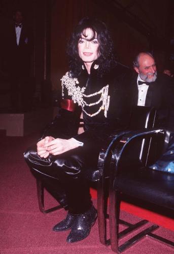 Michael Jackson - Michael Joseph Jackson (born August 29, 1958) is an American musician, entertainer and pop icon, whose successful music career and controversial personal life have been a part of pop culture for the last quarter-century.  Jackson began his musical career at the age of seven as the lead singer of The Jackson 5 and released his first solo recording, Got to Be There in 1971, while remaining a member of the group.[2] He began a full-fledged solo career in 1979 and formally parted with his siblings in 1984.[3] In his solo career, Jackson recorded and co-produced the best-selling album of all time, Thriller, which was named as the world's best-selling album at the 2006 World Music Awards. It has worldwide sales exceeding 104 million.[4] Michael Jackson has received thirteen Grammy awards[5] and charted thirteen number-one singles in the United States.  Throughout his four-decade career, Michael Jackson has been awarded numerous honors including the World Music Award's Best-Selling Pop Male Artist of the Millennium, American Music Award's Artist of the Century Award[6] and the Bambi Award's Pop Artist of the Millennium Award.[7] He is a double-inductee of the Rock and Roll Hall of Fame (once as a member of The Jackson 5 in 1997, and as a solo artist in 2001)[8] and an inductee of the Songwriters Hall of Fame.[9] Raymone Bain, Jackson's PR, claims that Jackson has sold over 750 million units worldwide.[10]  From 1988 to 2005, Jackson lived on his Neverland Ranch property, on which he built an amusement park and private zoo that was frequently attended by disadvantaged and terminally ill children. Rumours of sleepover parties received disparaging media coverage after it was revealed that children frequently slept in his bed or bedroom. These first came to light when he was accused of child sexual abuse in 1993. Michael Jackson's relationship with children was brought into the spotlight again in 2003 during the TV documentary Living with Michael Jackson. This resulted in Jackson being tried, and later acquitted, of more child molestation allegations and several other charges in 2005. Contents [hide] 1 Biography  1.1 1966–1980: Early life and career 1.2 1982–1986: The Thriller era 1.3 1987–1990: Bad and controversies 1.4 1991–1994: Dangerous and further career 1.5 1995–2000: HIStory and Blood on the Dance Floor 1.6 2001–2003: Invincible, Berlin and Martin Bashir 1.7 2003–2006: Trial, acquittal and the aftermath 1.8 2006–present: Visionary, Tokyo and the World Music Awards 2 Discography  2.1 Studio albums 2.2 Number-one singles  2.2.1 US number-one singles 2.2.2 UK number-one singles 3 Filmography  3.1 Notable music videos 3.2 Films 3.3 Videos/DVDs 3.4 Television 3.5 Video games 4 Music samples 5 Further reading 6 References 7 See also  7.1 Michael Jackson articles 7.2 Other related articles 8 External links  Biography  1966–1980: Early life and career Main articles: The Jackson 5 and Off the Wall   The cover to Michael Jackson's 1971's Got to Be There.  Michael Jackson was born in Gary, Indiana. He is the second-youngest brother of seven and the eighth of ten children of Joseph and Katherine Jackson. In 1966, after taking co-lead singing duties with brother Jermaine, the group's name changed from The Jackson Brothers to The Jackson 5. The group played at local clubs and bars, building up a following and eventually signing a contract with Motown Records in 1968.[11] The group hit stardom, with their first four singles which charted at number-one on the Billboard Hot 100. As a solo artist, Jackson released Got to Be There and Ben in 1972. These were released as part of the Jackson 5 franchise and produced successful singles such as 'Got to Be There', 'Ben', and a remake of Bobby Day's 'Rockin' Robin'.  The group's sales declined after 1973, and the group chafed under Motown's strict refusal to allow the Jacksons creative control or input. In 1976, the group signed a new contract with CBS Records (first joining the Philadelphia International division and then Epic Records).[12] When this became apparent to Motown Records, they sued the group for breach of contract.  As a result of the legal proceedings, which were complicated further by the fact that Jermaine Jackson was married to the daughter of Motown president (Berry Gordy), the Jacksons lost the rights to use the 'Jackson 5' name and logo and also Jermaine, who wanted to stay at Motown.[13] They changed their name to 'The Jacksons', featuring youngest brother Randy in Jermaine's place, and continued their successful career, touring internationally and releasing six more albums between 1976 and 1984, with Jermaine eventually re-joining in 1983, making them a sextet.  In 1978, Jackson starred as the scarecrow in The Wiz with former-label mate Diana Ross playing Dorothy.[14] The songs for the musical were arranged by Quincy Jones, who established a partnership with Jackson during the film's production and agreed to produce his first solo album in four years. Off the Wall, released in 1979, was a worldwide hit, and became the first album in history to spawn four top-ten hits, including 'Don't Stop 'Til You Get Enough' and 'Rock with You'.[2]  In January 1980, Jackson won his first awards for his solo efforts at the American Music Awards. He won 'Favorite Soul/R&B Album' (for Off the Wall), 'Favorite Male Soul/R&B Artist' and Favorite Soul/R&B Single (for 'Don't Stop 'Til You Get Enough').[2] Later that month, he also won two Billboard Awards (for 'Top Black Artist' and 'Top Black Album').[2]  On February 27, 1980, Jackson won a Grammy Award for 'Best R&B Vocal Performance, Male' (for 'Don't Stop 'Til You Get Enough').[2]  1982–1986: The Thriller era Main articles: Thriller (album), We Are the World, and Captain EO   The original album cover to 1982's Thriller.  In November 1982, the storybook for E.T.: The Extra-terrestrial was released. It included Jackson reading the story as well as one original song ('Someone in the Dark'). The album later won a Grammy for 'Best Album for Children'.  In December 1982, Jackson released his second Epic album, Thriller, which became the best-selling album in music history. The album spawned seven hit singles, including 'Billie Jean' (which was the first music video by a black artist to receive regular airplay on MTV), 'Beat It' and the album's title track which was accompanied by a revolutionary music video. The thirteen-minute Thriller was critically acclaimed, and massive airplay lead to it being packaged with the featurette Making Michael Jackson's Thriller on VHS, where it became the best-selling music home video ever.[15] Thriller spent 37 weeks at number-one and remained on the Billboard album chart for 122 weeks. It was eventually certified 27x Platinum in the United States.[16]   Jackson with the Reagans in 1984.  In 1983, whilst performing 'Billie Jean' at the Motown 25: Yesterday, Today, Forever concert Jackson debuted what can be regarded as his signature move: the moonwalk.[15] In 1983, he started a sponsorship deal with Pepsi-Cola, and, as part of the deal, he agreed to star in a commercial. While filming a Pepsi commercial with his brothers in 1984, before a live audience, his hair caught on fire when a pyrotechnic effect went wrong. Jackson suffered serious burns on his scalp, which required skin grafts.[17]  In February 1984, Jackson is nominated for twelve Grammy awards and wins eight,[15] breaking the record for the most Grammy Awards won in a single year.[18] Seven were for the critically acclaimed Thriller and the other for the E.T.: The Extra-terrestrial storybook. In 1984, he also won eight American Music Awards and the 'Special Award of Merit' and three MTV Video Music Awards.  After reuniting with his brothers, he then helped to write the Victory album. He then performed and starred in the successful Victory Tour which started on July 6, 1984 and lasted for five months.[15]  In 1985, Jackson was invited to the White House and was personally thanked by then-President Ronald Reagan at a White House ceremony for donating the song 'Beat It' for use in drunk driving prevention television and radio public service announcements.[19]   Jackson continued his charity work in 1985 by co-writing, with Lionel Richie, the hit single 'We Are the World'. The charity single helped to raise money and awareness for the famine in East Africa and was one of the first instances where Jackson was seen as a humanitarian. The song also won a Grammy Award for 'Song of the Year'.[15]   Jackson in the video for 'Beat It'.  Controversy began when Jackson purchased shares in the ATV Music Publishing (a company which owned the rights to most of the Beatles' songs), making himself the majority shareholder. This move angered close friend and songwriter Paul McCartney, who had also made a bid for the company. Ironically, it was McCartney who advised Jackson on the merits of song ownership.[20] Their creative co-writing ended after this event. Following this controversial business deal, tabloid stories of Jackson sleeping in a hyperbaric oxygen chamber to stall the aging-process, and an allegation claiming Jackson attempted to purchase the bones of the Elephant Man inspired the pejorative nickname 'Wacko Jacko'. The name 'Wacko Jacko' would come to be detested by Jackson.[21]  In 1986, Jackson starred in the George Lucas-produced, Francis Ford Coppola-directed 3-D film Captain EO. The film lasted 17 minutes but had costs estimated at $17 million.[22] At the time, it was the most expensive film ever produced on a per-minute basis. In the USA, the Disney theme parks hosted Captain EO. Disneyland featured the film in tomorrow-land from September 18, 1986 until April 7, 1997. It was also featured in Walt Disney World in Epcot from September 12, 1986 until July 6, 1994. Two new songs featured in the film. These were 'Another Part of Me', which later appeared on Bad, and 'We