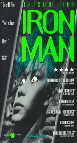 tetsuo - Tetsuo: The Iron Man is a 1988 Japanese film by cult-film director Shinya Tsukamoto. This, his third film, is an extremely graphic but also strikingly-filmed fantasy shot in the same low-budget, underground-production style as his first two films. Tetsuo established Tsukamoto internationally and created his worldwide cult. It was followed by Tetsuo II: Body Hammer. The film opens with a man (called only'the man', or sometimes the'Metals Fetishist') tearing open a massive gash in his leg and shoving in a piece of scrap metal. Upon seeing maggots festering in the wound, he screams, runs out into the street, and is hit by a car. The driver of the car (cult actor Taguchi Tomorowo) tries to cover up the mess by dumping the body into a ravine, but the dead man comes back to haunt him -- by forcing his body to gradually metamorphose into a walking pile of scrap metal. In one of the film's most controversial sequences, the man discovers his pnis has mutated into a gargantuan power drill, and his girlfriend willingly copulates to death upon it. The film ends with a duel between the man and the Fetishist with the pair transformed into a giant mutated monster. One of the main themes of the movie is the main character's latent homosexuality. Some critics have seen this film as being a literal use of a metaphor, showing mankind's dehumanization and'becoming the machine'. The scene involving the businessman killing his girlfriend with his own pnis-turned-powerdrill is indicative of the dehumanization. The setting, which shows modern Japan as an industrial wasteland, suggests a post-apocalyptic nightmare. Some critics have suggested that Shinya Tsukamoto was making a statement on the dehumanization of industrialized Japan and the Japanese corporate culture. The film can also be seen as a comment on impotence as a metaphor for the feeling of alienation and helplessness in the face of byzantine corporate culture and modern urban life. The main character 'salary man' and his wife react with sexual arousal after they run over the metal fetishist, and the salary man is very different after the appearance of his'power tool pnis' from his former corporate-puppet-self. It is suggested that this state of virility is different from before the hit and run accident. The iron/machine-mutation comes to represent personal empowerment, with both good and bad sides to it. This is even further underscored by the shape of the mutated creature which appears at the end of the film, which is more than a bit similar to an erect pnis. It has been often discussed that Tetsuo is a metaphor for the spread of the AIDS virus. The film is Unrated but contains substantial strange violent and sexual imagery. The film is also discussed in Clive Barkers'A-Z Book of Horror'. The DVD has been released in America and elsewhere from Tartan Asia Extreme.